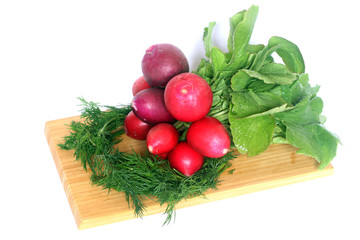 bunch of fresh radish and fennel on wooden board
