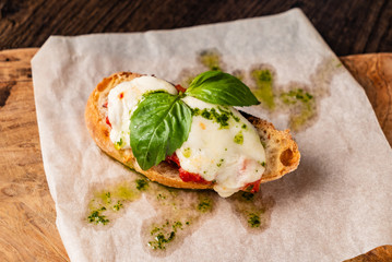Traditional italian bruschetta with cherry tomatoes, cream cheese, basil leaves