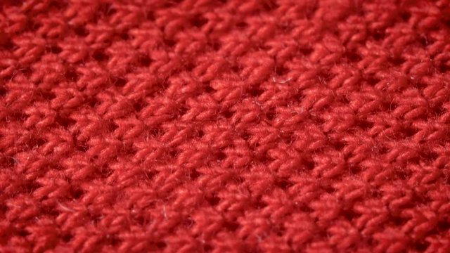 Red cotton fabric with polyester, which is used for sewing polo shirts. Weave a pike. Macro shoot. Close up.