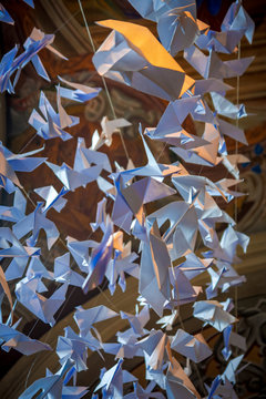 Origami white paper doves hanging on a rope