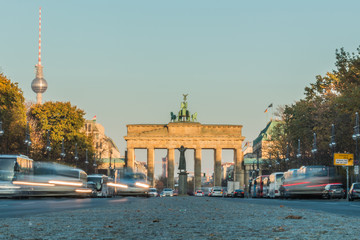 Back side of the Brandenburg Gate from the ground perspective with road traffic in the long exposure. TV tower next to the Brandenburg Gate at autumn vibes © Marco