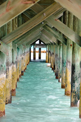 underside view of rustic wooden pier in Nassau Bahamas