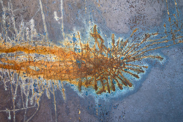 close up of abstract rust stain on blue metal surface