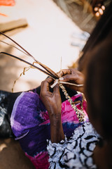 woman weaving banana leaves in Uganda, Africa