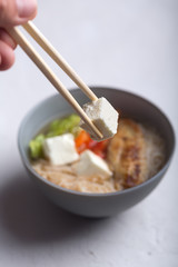 Traditional spicy asian soup with tofu cheese and noodles