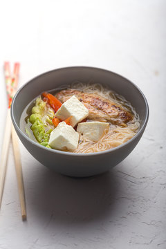 Traditional spicy asian soup with tofu cheese and noodles