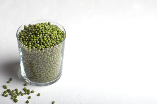Green soy beans in a glass on the white background
