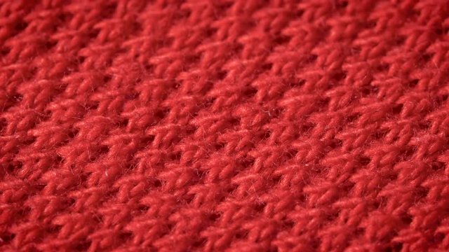 Red cotton fabric with polyester, which is used for sewing polo shirts. Weave a pike. Macro shoot. Close up.