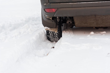Moscow, Russia - December 25, 2018: The wheel is buried in the snow. The car goes on a winter field.
