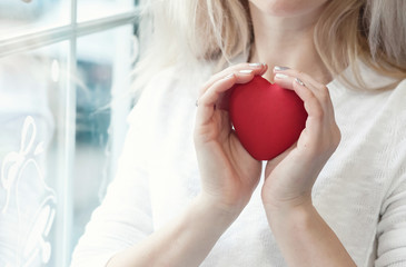 Woman take care a red heart 