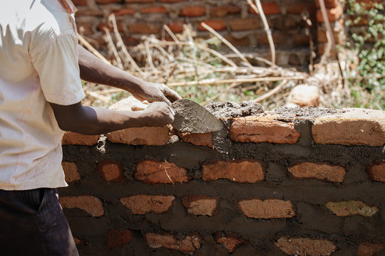 Man Building A House In Uganda, Africa