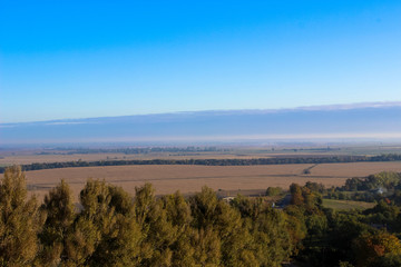 Wonderful panoramic landscape view of on hills with a long horizon and beautiful blue sky
