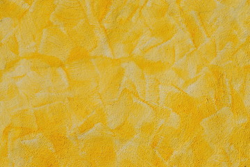 Yellow-orange wall decorated texture in the Mediterranean style.