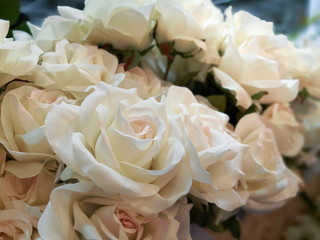 Artificial orange rose flower in small bouquet