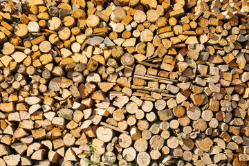 background of wooden logs - chopped fire wood prepared for winter