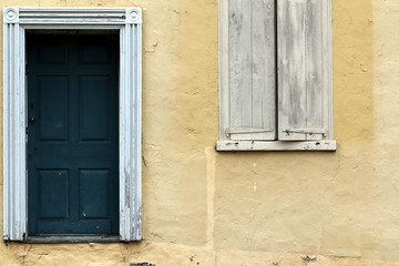The green door and pale yellow are the colors of this old house.
