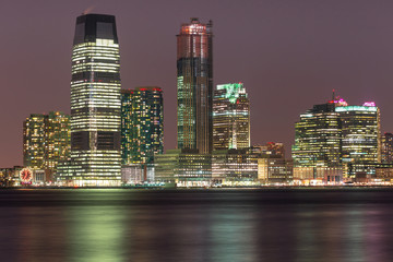 View on Jersey city skyscraper from Hudson river at night  with long exposure 