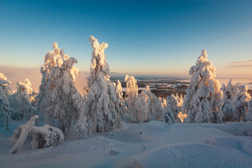 Ski resort snow covered landscape. Sunny frosty day. Lapland Finland