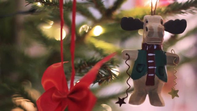 Beautiful Christmas Fir Tree Toy in Shape Funy Deer. Christmas Tree With Defocused Blurred Lights Bokeh. Christmas Tree With Bokeh Background.