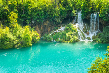 Waterfall at a turquoise lake. The Plitvice Lakes National Park, Croatia, Europe.