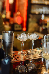 Glasses with ice. The barman is preparing strong alcoholic beverages.