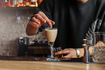 The barman is preparing a cocktail. The process of drinking.