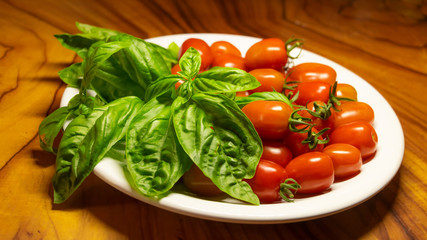 A plate of Fresh organic tomatoes and basil 