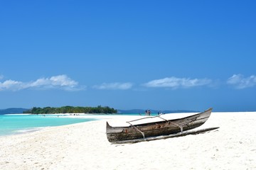 Naklejka na ściany i meble Boat in the sand of a tropical beach