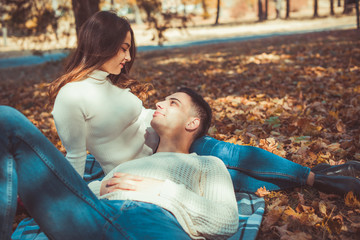 Divine couple lying in autumn park