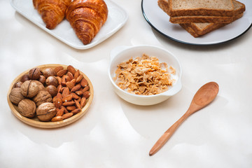 Health and colorful breakfast - waffles, muffins, almond, hazelnuts, various fresh fruits on table. Health food concept .Top view.