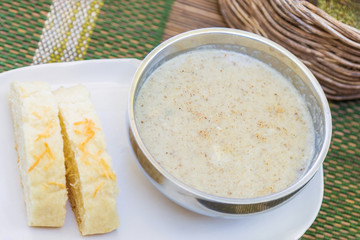 Creamy hot musroom soup served with bread on the table