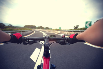 Fototapeta na wymiar Woman cyclist riding Mountain Bike on highway
