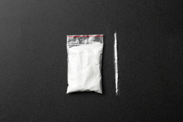 Flat lay composition with cocaine on dark background