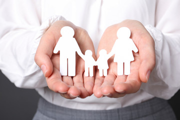 Fototapeta na wymiar Woman holding cutout paper family, closeup. Life insurance concept