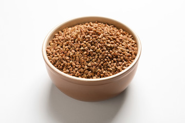 Bowl with buckwheat on white background. Natural food high in protein