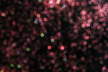 Color glitter on dark background. Bokeh effect