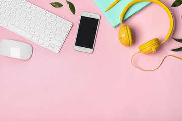 Flat lay composition with smartphone, computer keyboard and headphones on color background. Space...