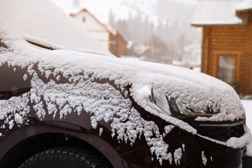 Car covered with snow after storm outdoors on beautiful winter day, closeup