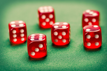 several red dice for board games on a green background