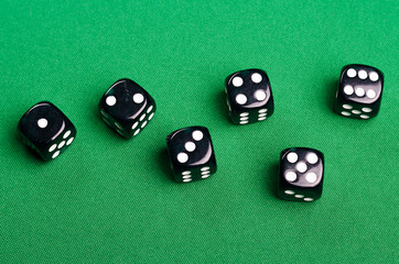 black gambling dice for casinos on a green background