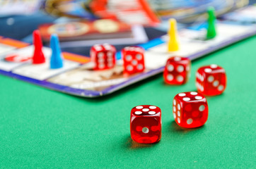 several red dice for board games on a green background