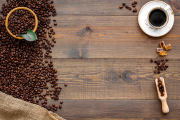 coffee bean and cup of americano on wooden table background top view mockup
