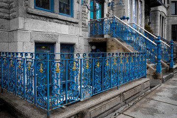 Montreal / Canada - April 22, 2016: Beautiful Victorian painted cast iron fence and railings, stone houses