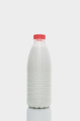 Milk bottle with red cap  isolated on white background