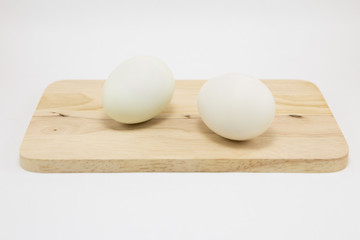 Fresh white eggs on a wooden cutting board