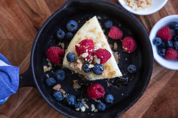 Cheesecake with Berries and Honey Served in a Cast Iron Skillet.