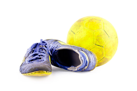 Old  Football Shoes Damaged And Old  Dirty Yellow Futsal Ball On White Background Football  Object Isolated