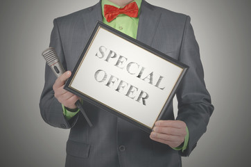 Special offer border frame and a microphone in a manager hand isolated on a gray background.