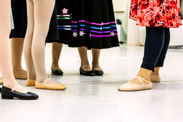 Group of young girl ballet students with teacher during practice for character study class. Ballet slippers, character shoes, stockings and character skirt. Landscape format with copy space worms view © EdwardsMediaOnline