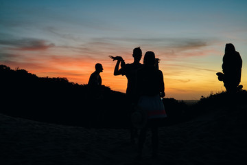Fototapeta na wymiar Friends playing in the sunset